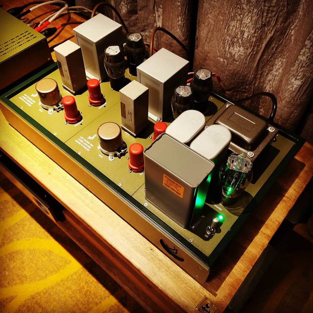 A finished Soundaries tube amplifier glowing in its wooden frame